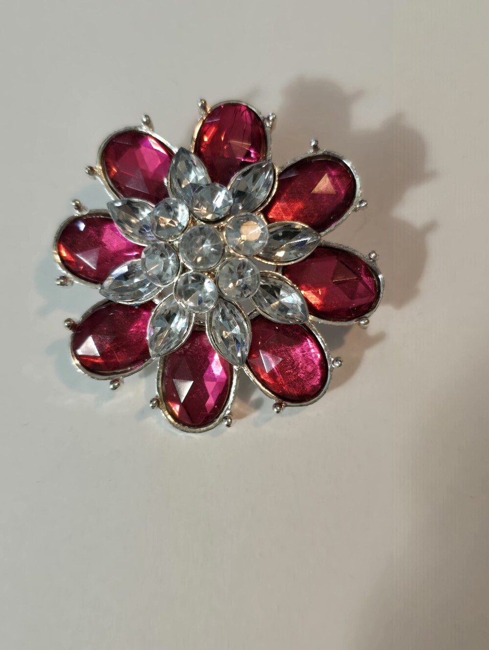 Floral Corsage Brooch, crafted in a silver-tone metal Red And Clear Rhinestones